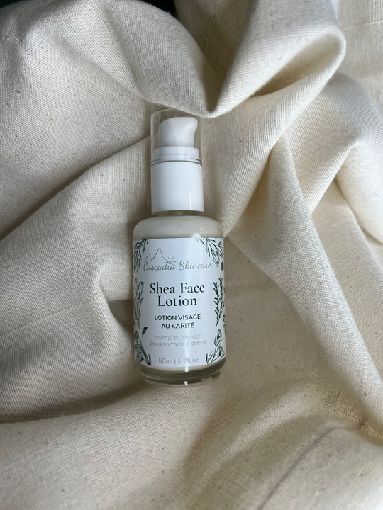 Shea face lotion bottle on a textured beige fabric background